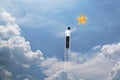 Businessman climb up on ladder to reach star, successful and win concept