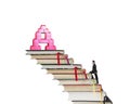 Businessman climbing books stairs toward alphabet A shape blocks Royalty Free Stock Photo