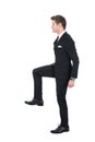 Businessman climbing imaginary steps