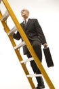 Businessman climbing ladder. Royalty Free Stock Photo