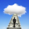 Businessman climbing the money stairs toward white cloud