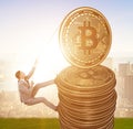 Businessman climbing the stack of bitcoins