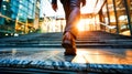 Businessman climbing stairs with sunlight ahead. Business person, professional-looking entrepreneur with legs and shoes close up.