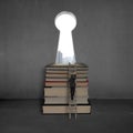 Businessman climbing to top of books with key shape door Royalty Free Stock Photo