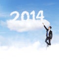 Businessman climbing upward to 2014 Royalty Free Stock Photo