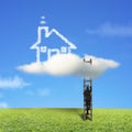 Businessman climbing on wooden ladder to reach cloud house