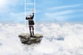 Businessman climbs stairs above clouds