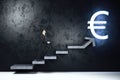 Businessman climbs stairs to a euro sign Royalty Free Stock Photo