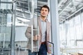 Businessman with clipboard entering the door in office Royalty Free Stock Photo