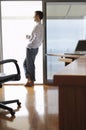 Businessman With Coffee Cup Leaning On Sliding Door Royalty Free Stock Photo