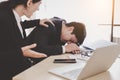 Businessman or colleagues guy sleeping during working with businesswoman. Workmate woman trying to wake up him but he still