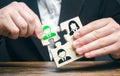 A businessman collects puzzles symbolizing a team of employees. The appointment of the head. Dismissal employee.