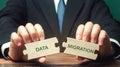 Businessman collects wooden puzzles with the words Data migration. Process of preparing, selecting, extracting data and