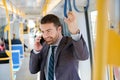 Businessman commuter is traveling and is talking Royalty Free Stock Photo