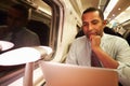 Businessman Commuting To Work On Train And Using Laptop Royalty Free Stock Photo