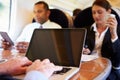 Businessman Commuting To Work On Train And Using Laptop