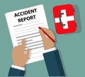 Businessman Completing Accident Report document beside First Aid Kit Health and Safety concept
