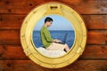 Businessman with computer, boat window view Royalty Free Stock Photo