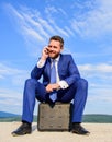 Businessman concentrated sit on briefcase blue sky background. Business decision concept. Take minute to analyze