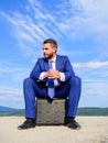 Businessman concentrated sit on briefcase blue sky background. Take minute to analyze. Business decision concept Royalty Free Stock Photo