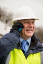 Businessman construction worker using mobile phone. Royalty Free Stock Photo