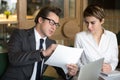 Businessman consulting with female colleague on contract conditi Royalty Free Stock Photo