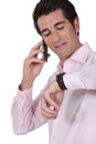 Businessman consulting his watch