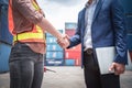 Businessman and Container Shipping Worker Handshake Together for Cooperation Shipment in Logistic Warehouse, Business Partnership Royalty Free Stock Photo