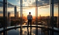 Businessman Contemplating Cityscape Through Floor-to-Ceiling Windows Reflecting on Corporate Success in Modern Office Tower at