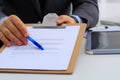 Businessman with contract giving pen to partner to sign it Royalty Free Stock Photo