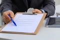 Businessman with contract giving pen to partner to sign it Royalty Free Stock Photo