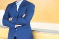 Businessman in a corporate suit standing in office space.