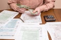 Businessman counting dollars with tax forms Royalty Free Stock Photo