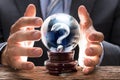 Businessman Covering Crystal Ball With Question Mark Royalty Free Stock Photo