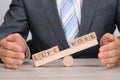 Businessman covering imbalance between life and work on seesaw