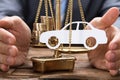 Businessman Covering Paper Car And Coins On Weighing Scale