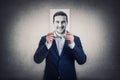 Businessman covers his head with a face print, like a fake mask for hiding real emotions. Sheet with positive face expression.