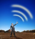 Businessman creating airwaves with antenna