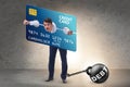Businessman in credit card burden concept in pillory