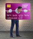 Businessman in credit card burden concept in pillory