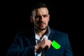 Businessman with a credit card. Business man in black suit put or take out creditcard in pocket, close up.