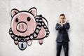 Businessman crosses arms with locked piggy bank Royalty Free Stock Photo