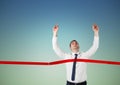 Businessman crossing finish line with arms up Royalty Free Stock Photo