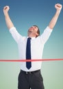 Businessman crossing finish line with arms up Royalty Free Stock Photo