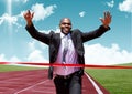 Businessman crossing finish line with arms up Royalty Free Stock Photo