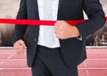 Businessman crossing the finish line in ground Royalty Free Stock Photo