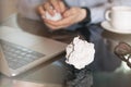 Businessman crumpling paper on his workplace.Office workplace with crumpled paper balls on the table