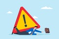 Businessman crushed under attention sign Royalty Free Stock Photo