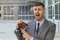 Businessman crying holding his empty wallet Royalty Free Stock Photo