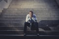 Businessman crying lost in depression sitting on street concrete stairs Royalty Free Stock Photo